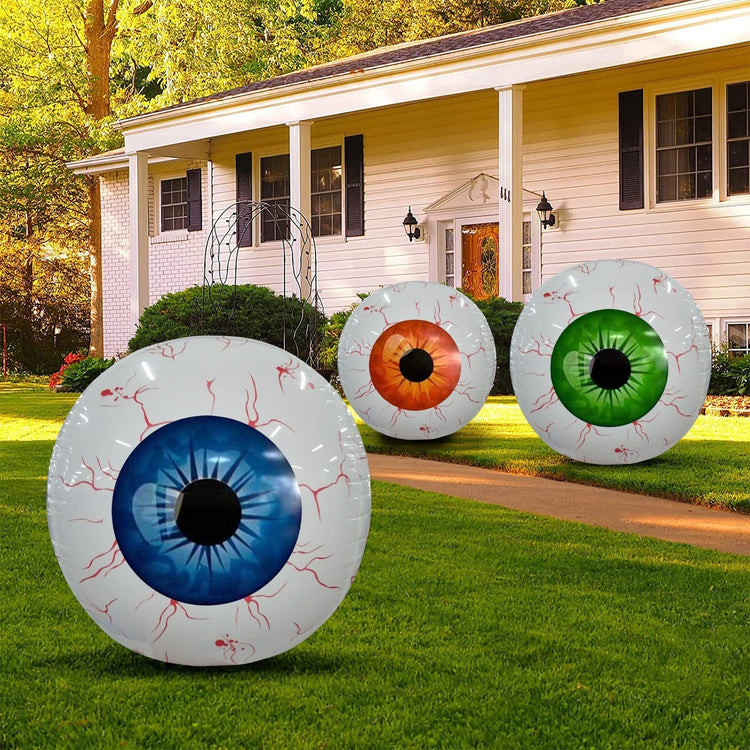 a house with a house and a yard with large inflatable eyeballs