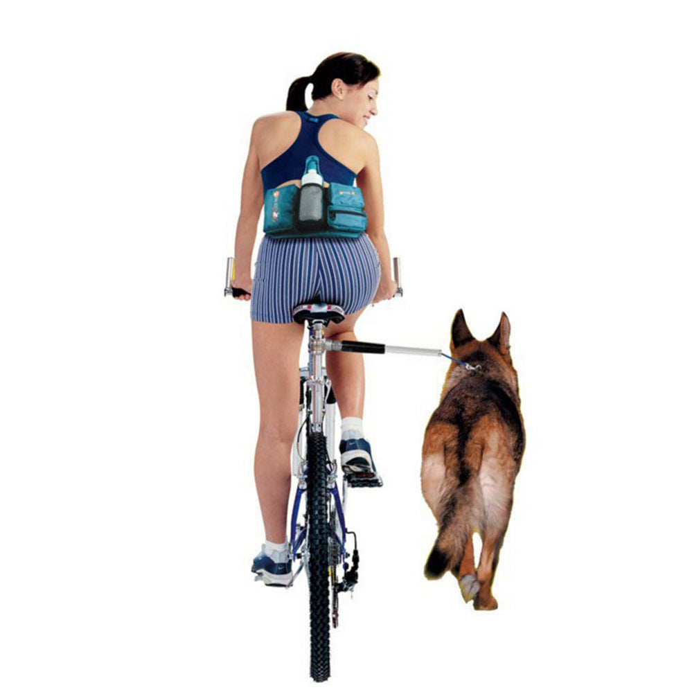 a woman riding a bicycle with a dog