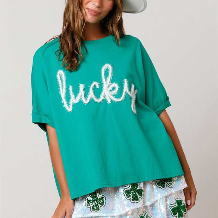 a woman wearing a hat and a green shirt