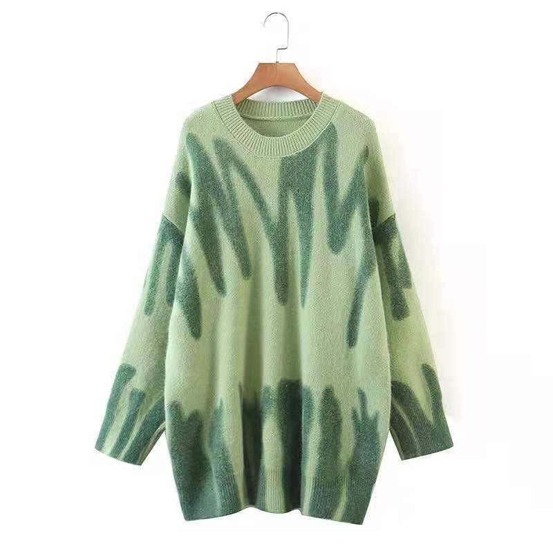 a green sweater on a swinger