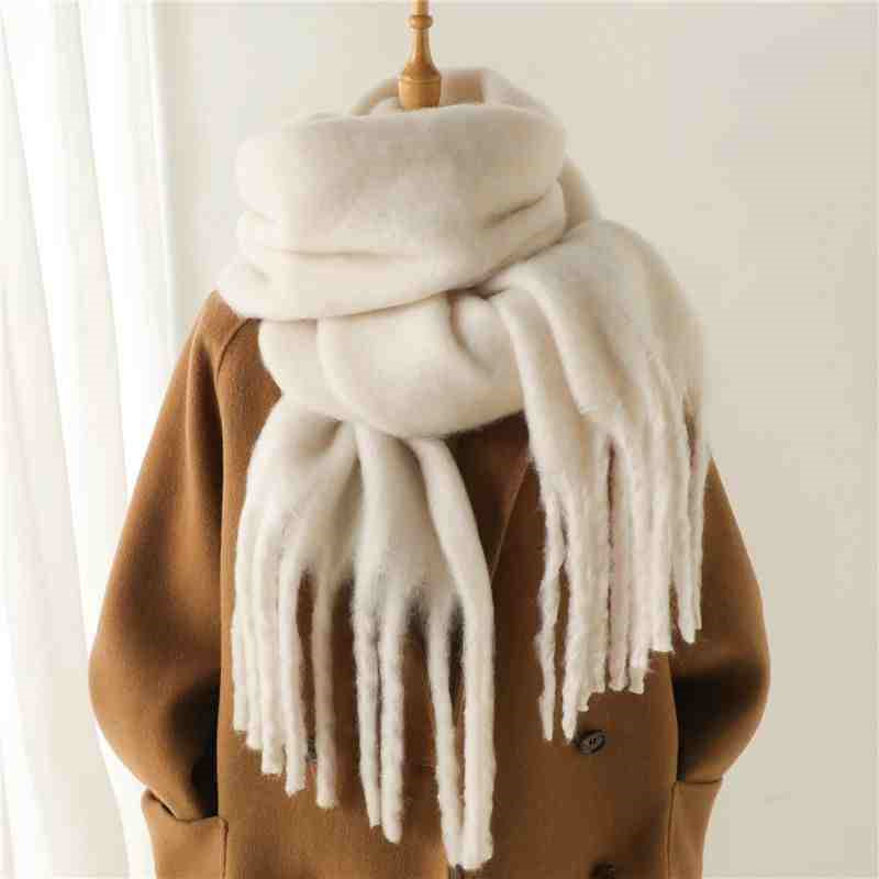 a coat and scarf on a mannequin