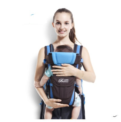 a woman holding a baby in a baby carrier