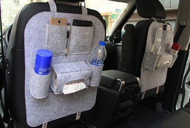 a car seat with a pocket and a bottle of tissue