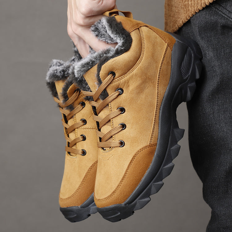 a person holding a pair of shoes