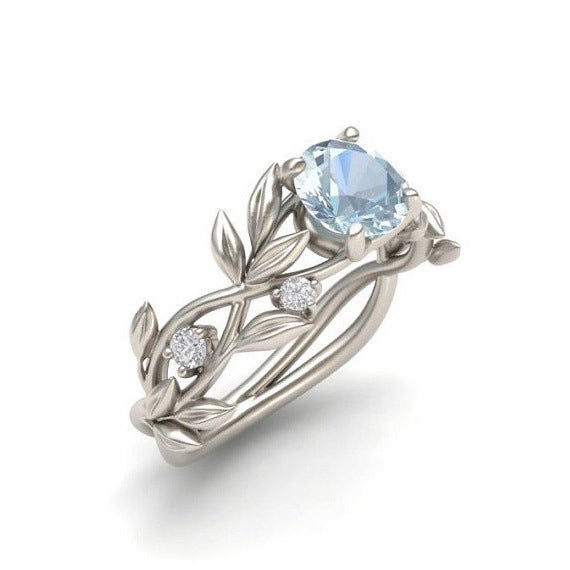 a silver ring with a blue stone
