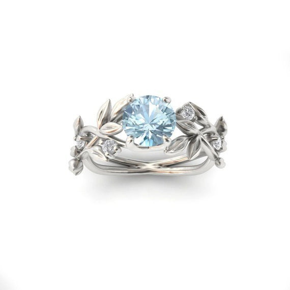 a silver ring with a blue stone