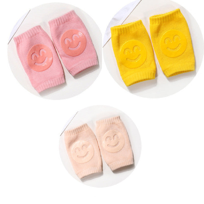 a pair of baby socks with smiley faces