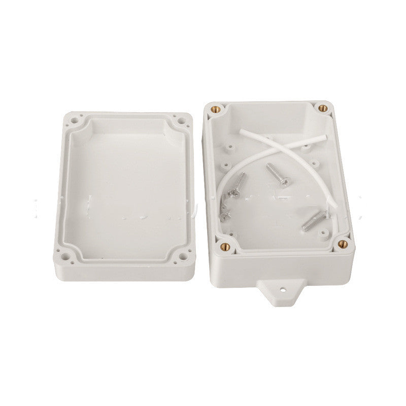 a white plastic box with screws