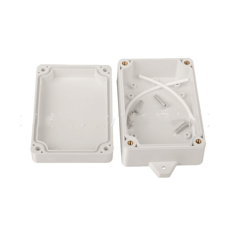 a white plastic box with screws
