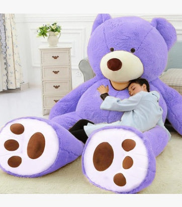 a person sleeping on a large teddy bear