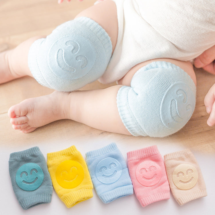 a baby's legs with smileys on them