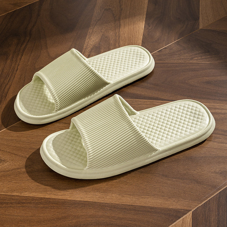 a pair of white slippers on a wooden surface