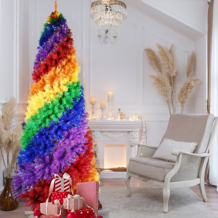 a rainbow colored christmas tree in a living room