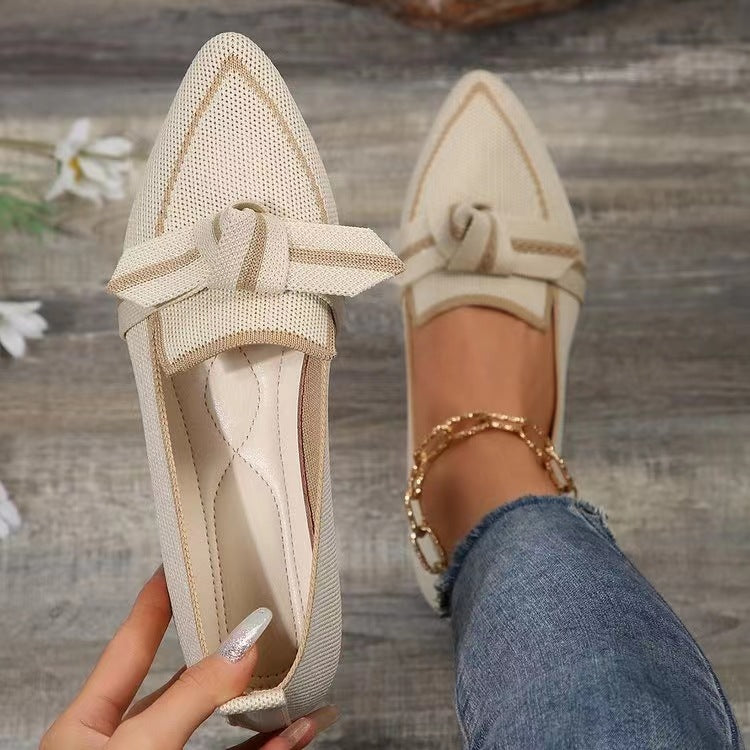 a person holding a pair of shoes