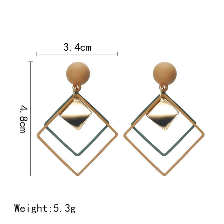 a pair of earrings with size comparison