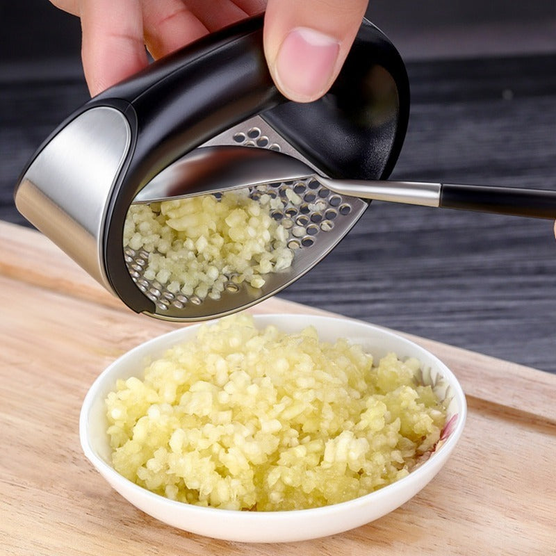 a hand holding a grater over a bowl of food