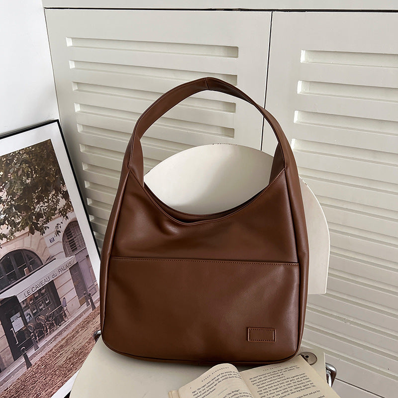 a brown purse on a chair