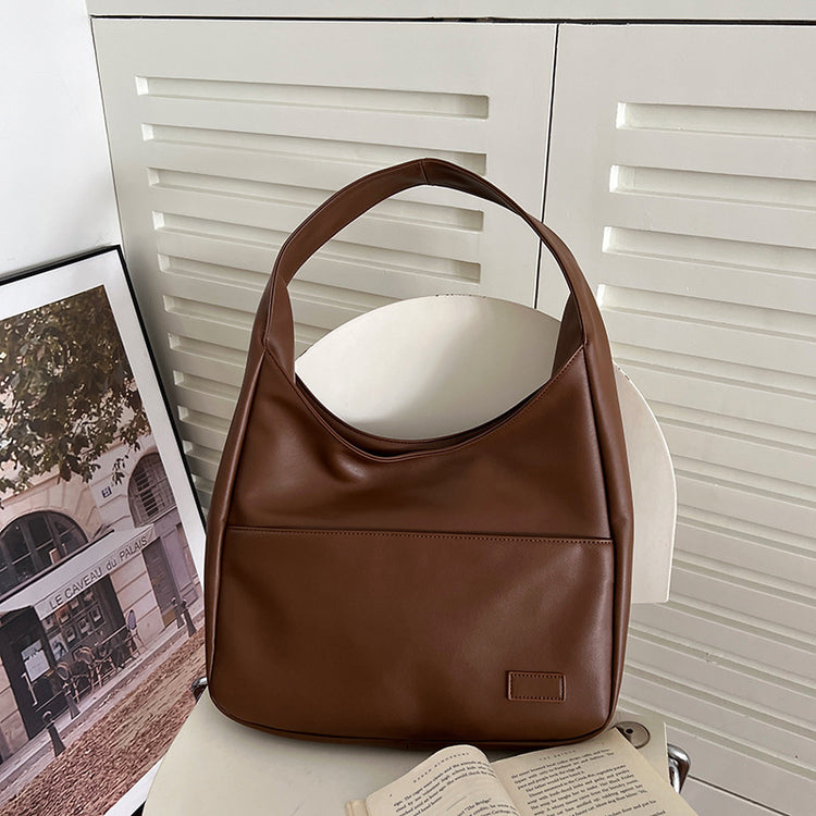 a brown purse on a chair