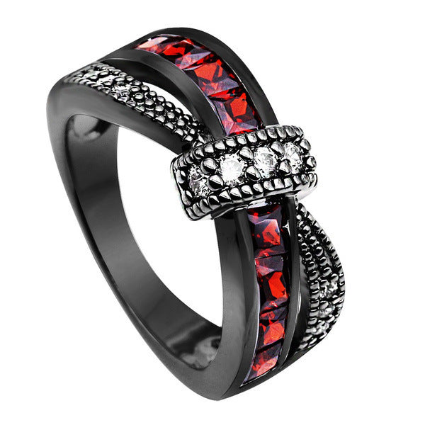a black ring with red and white stones