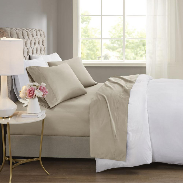 a bed with a lamp and flowers