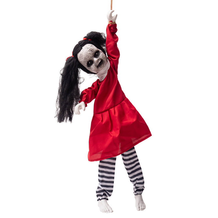 a doll with a red dress and black hair holding a stick