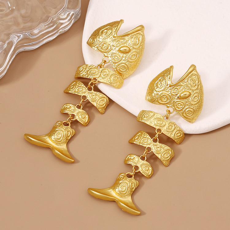 a pair of gold fish earrings