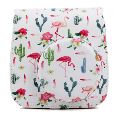 a white camera cover with pink flamingos and cactuses