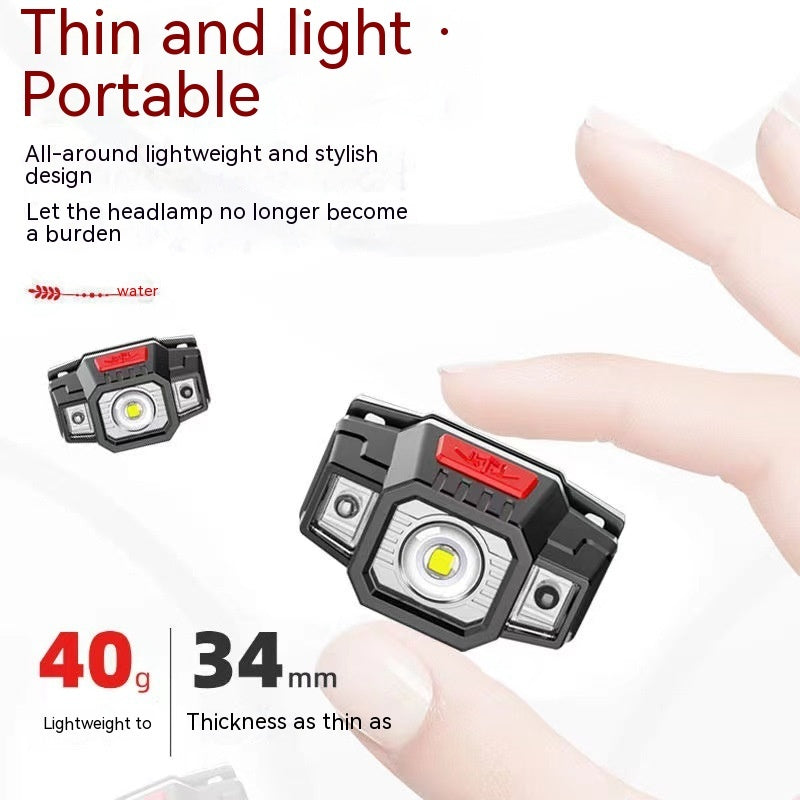 a hand holding a black and red flashlight