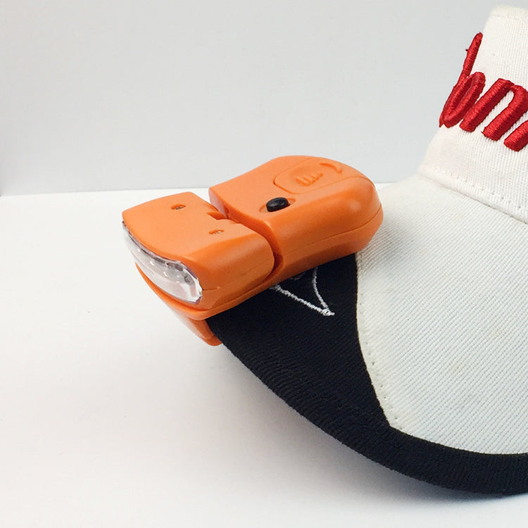 a white and black hat with an orange light on it
