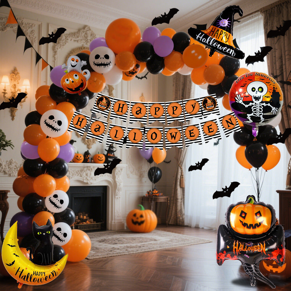 a halloween balloon arch with a banner and bats