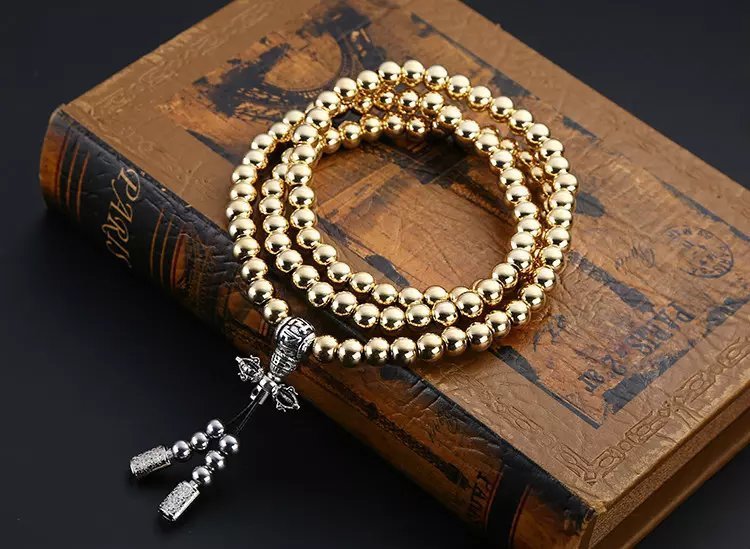 a gold necklace on a book
