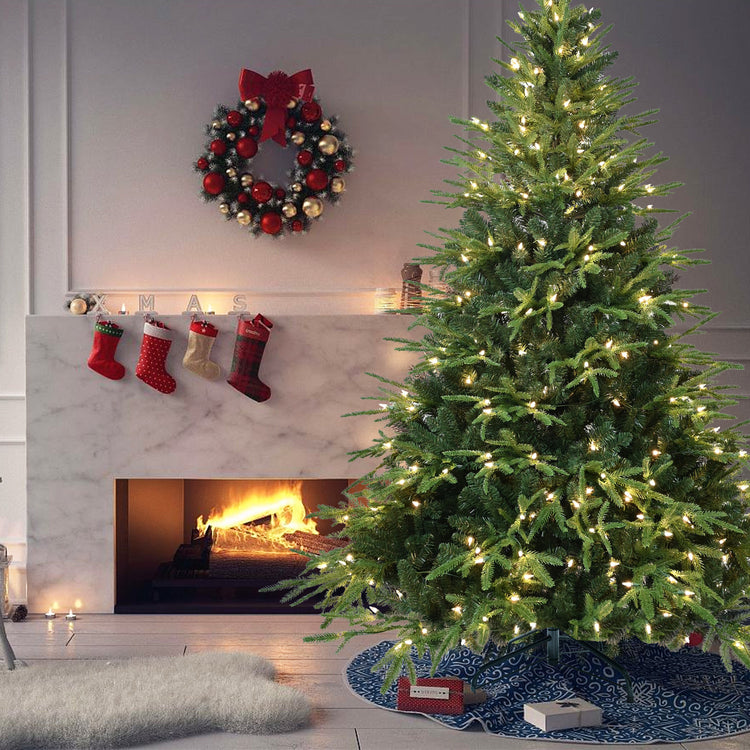 a christmas tree with lights and a fireplace