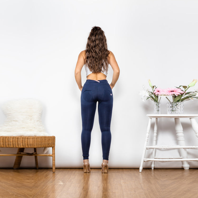 a woman standing in front of a wall