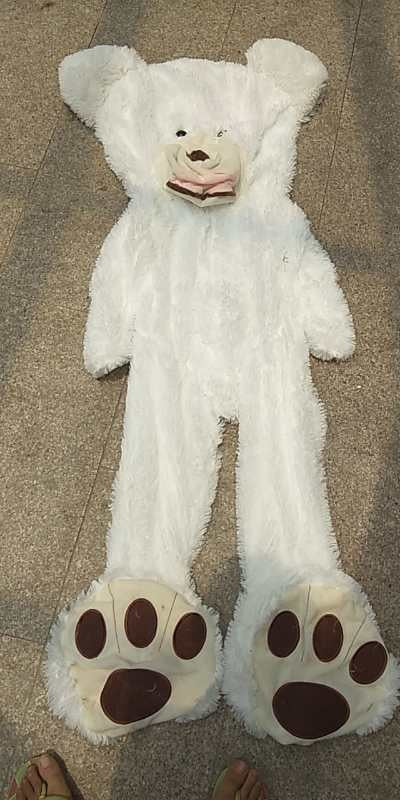 a white furry garment on the ground