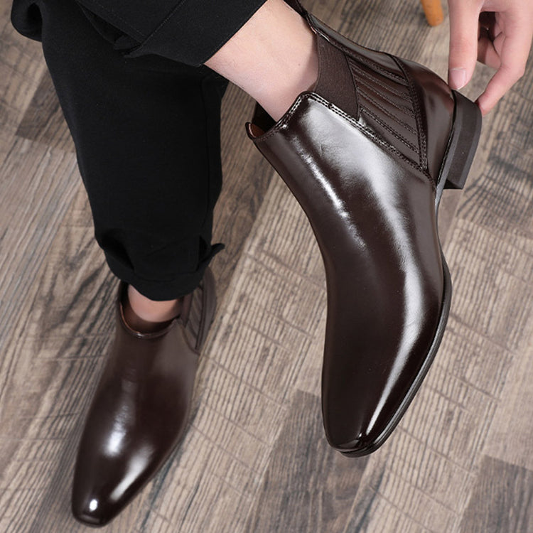 a person holding a brown shoe
