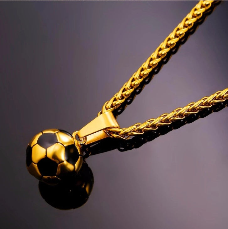 a gold chain with a football ball pendant