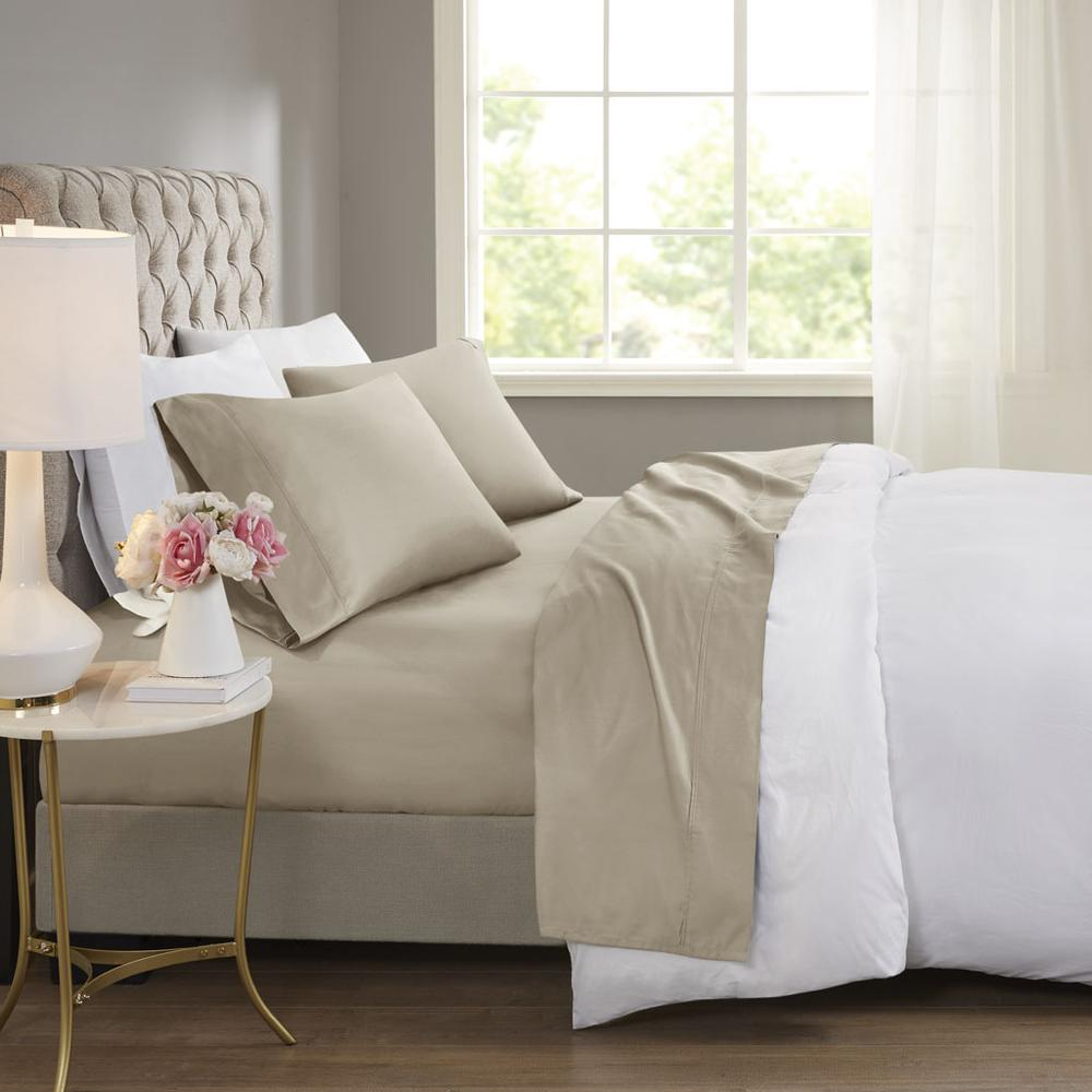 a bed with a lamp and flowers