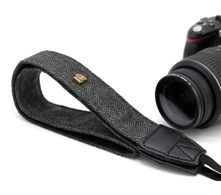 a camera strap with a strap attached to it