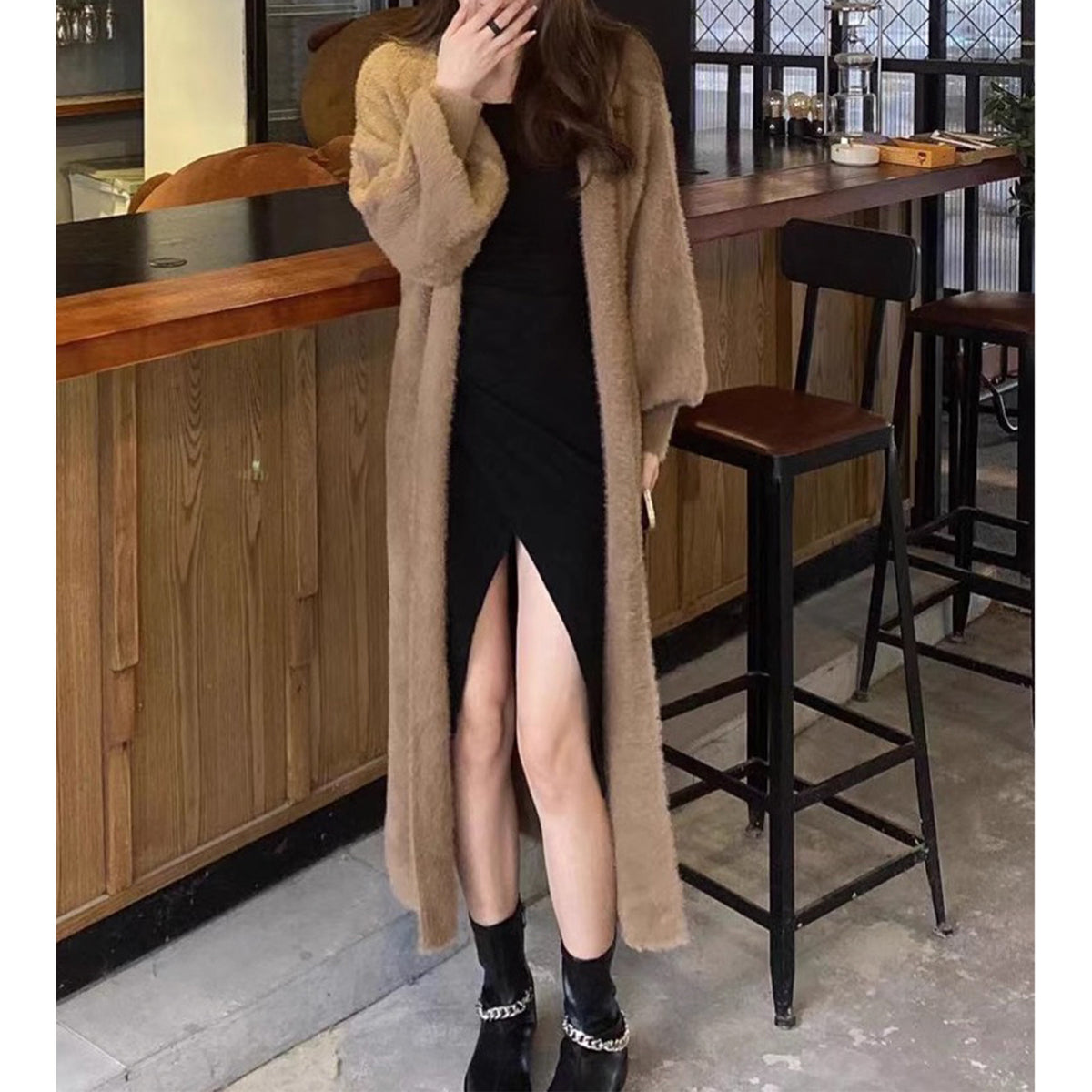 a woman in a long brown coat