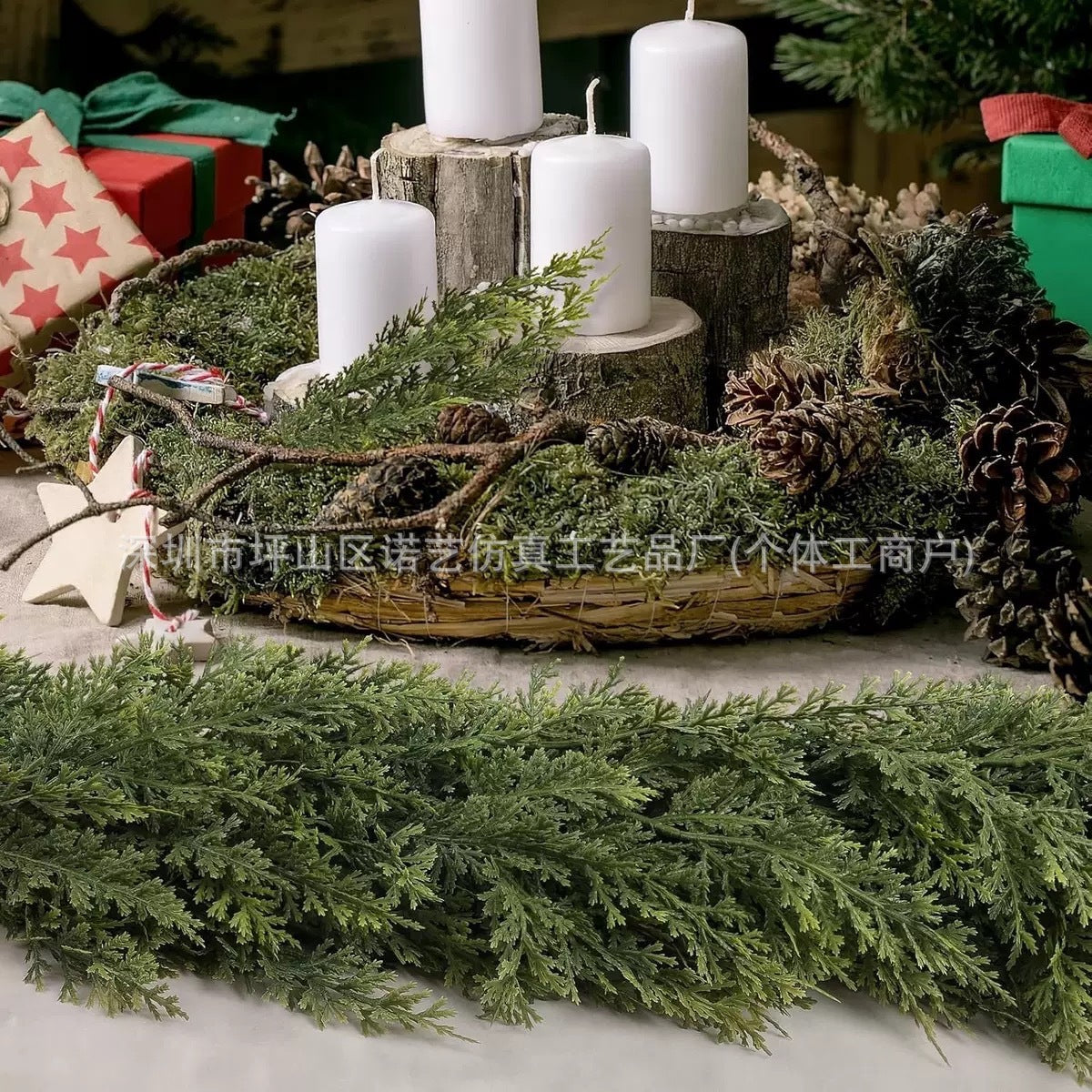 a candle and wreath with pine cones and a star