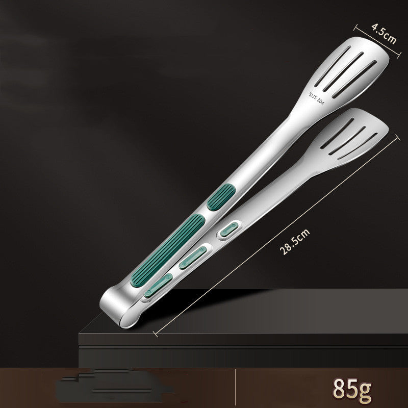 a pair of tongs on a black surface