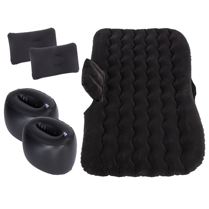 a black air mattress and pillows