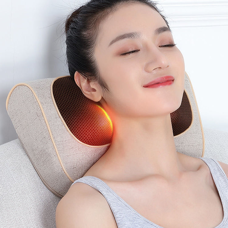 a woman lying on a pillow with a neck massager