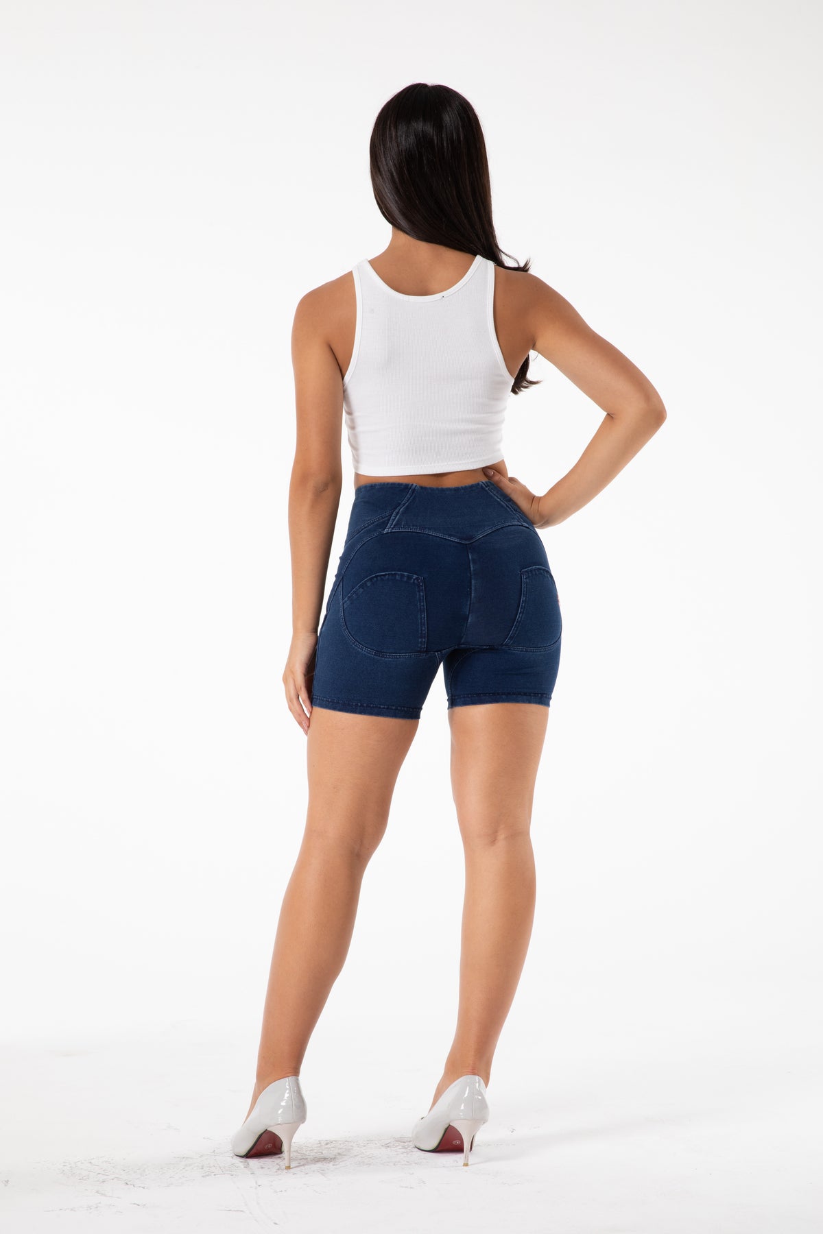 a woman in shorts and a white tank top