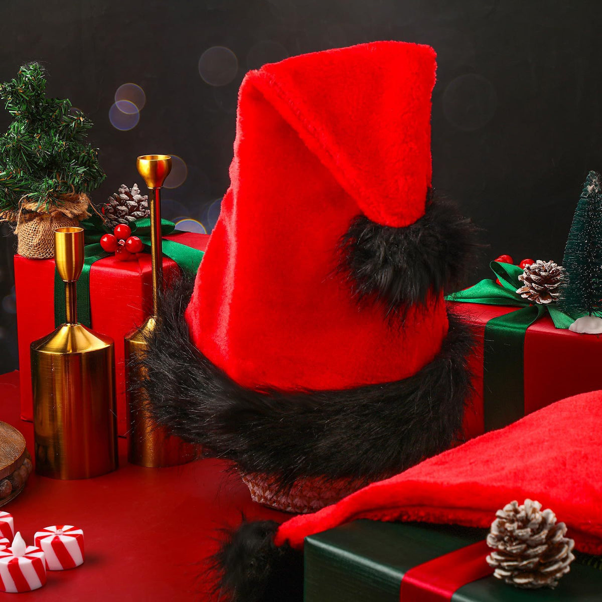 a red hat with black fur on a red table with presents
