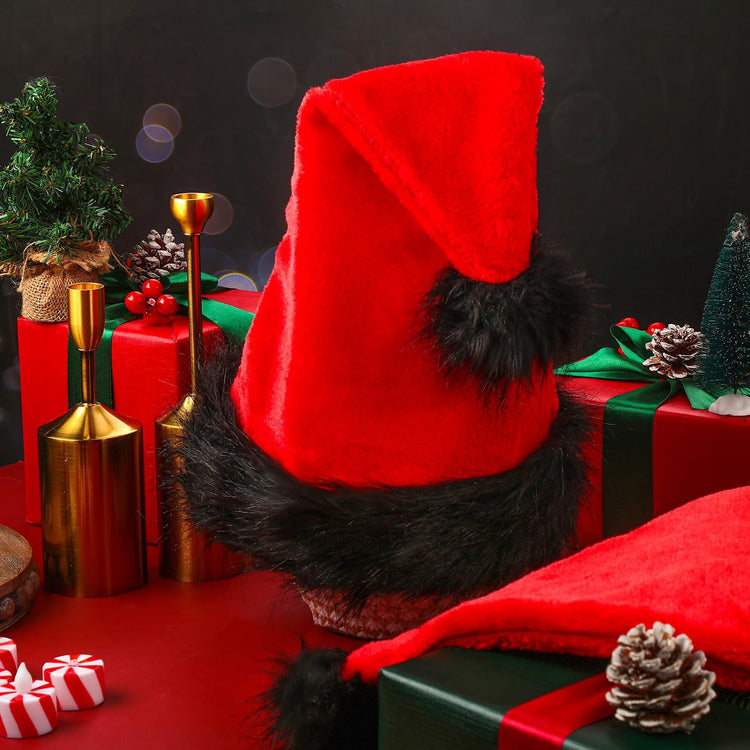 a red hat with black fur on a red table with presents