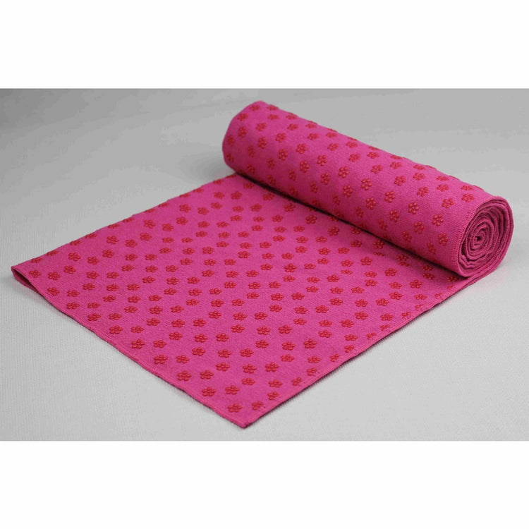 a pink rolled up yoga mat