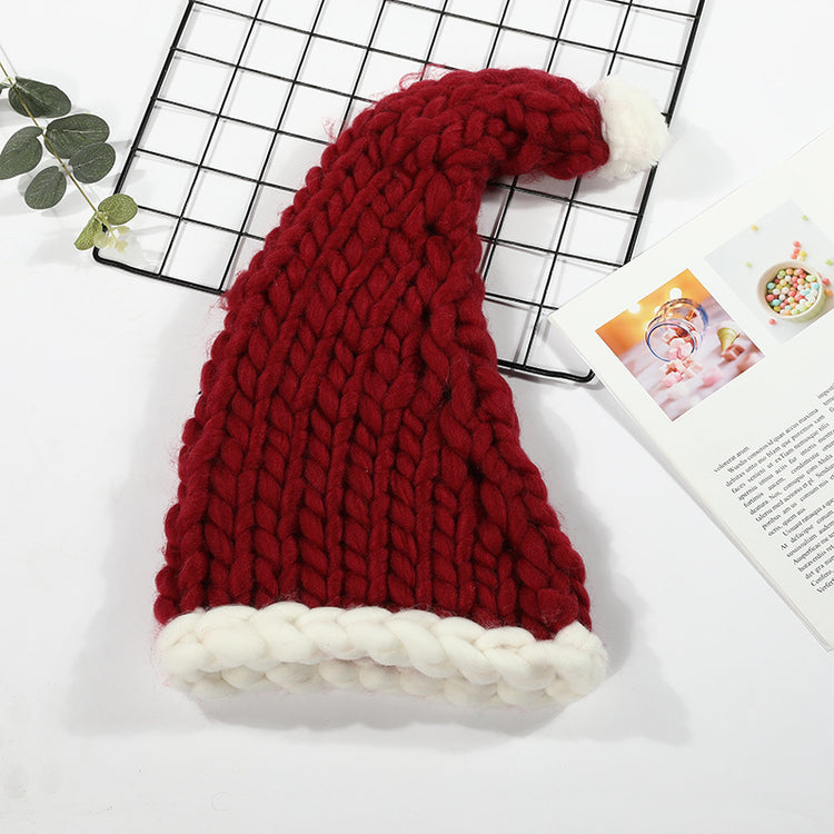a red and white knit hat on a black grid