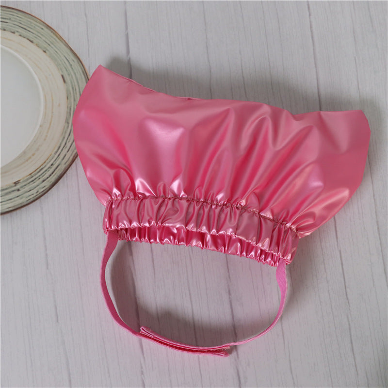 a pink hat on a white surface