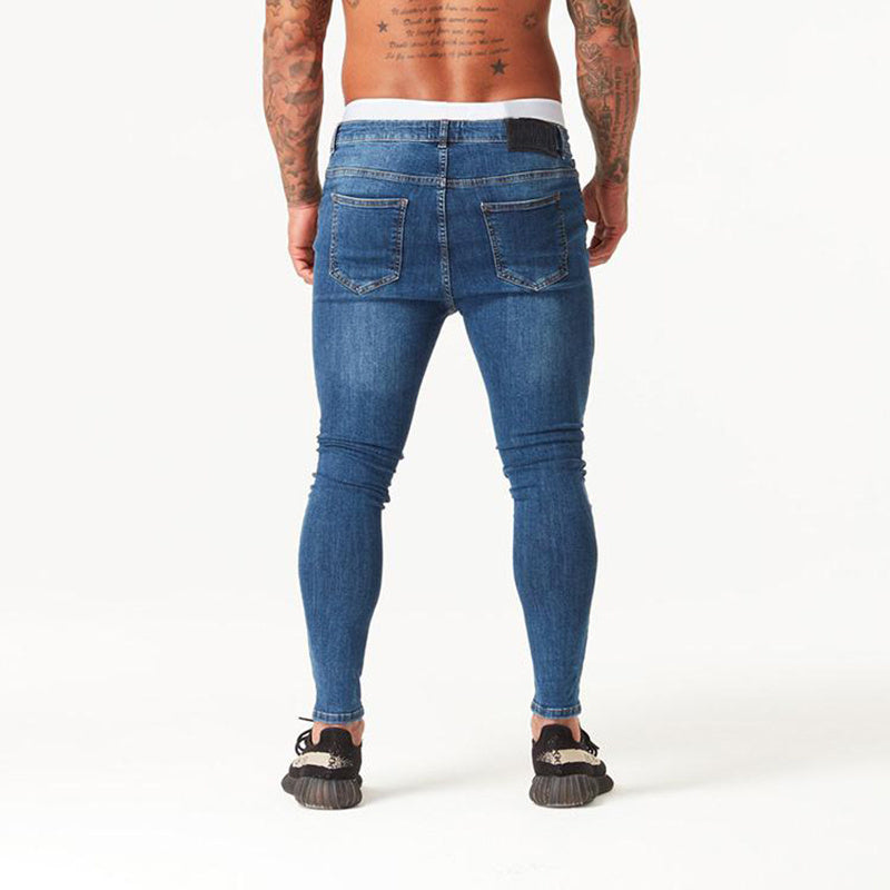a man wearing jeans and sneakers